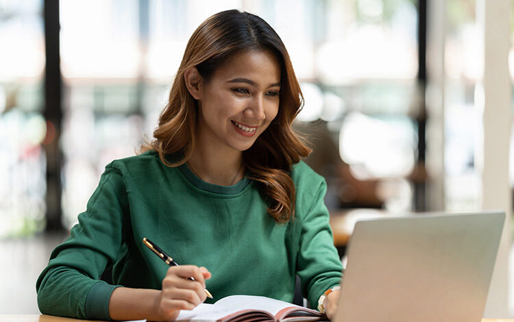 Participant on laptop with notebook