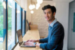 man typing on a laptop